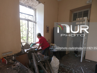 KHARKIV, UKRAINE - APRIL 27, 2024 - A woman removes glass shards from a windowsill at Psychiatric Hospital N3 in the Saltivskyi district fol...