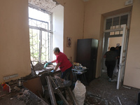 KHARKIV, UKRAINE - APRIL 27, 2024 - A woman removes glass shards from a windowsill at Psychiatric Hospital N3 in the Saltivskyi district fol...