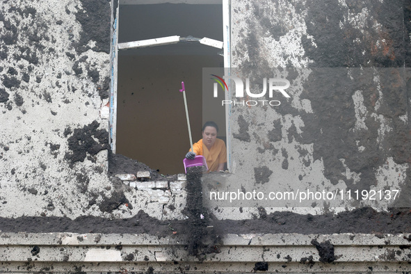 KHARKIV, UKRAINE - APRIL 27, 2024 - A woman removes soil from a windowsill at Psychiatric Hospital N3 in the Saltivskyi district following a...