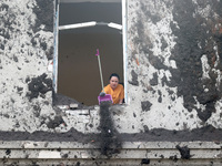 KHARKIV, UKRAINE - APRIL 27, 2024 - A woman removes soil from a windowsill at Psychiatric Hospital N3 in the Saltivskyi district following a...