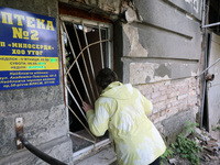 KHARKIV, UKRAINE - APRIL 27, 2024 - A woman looks inside through a grated window at Psychiatric Hospital N3 in the Saltivskyi district follo...