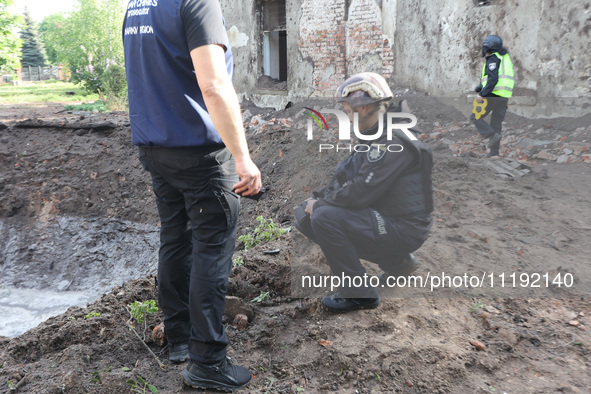 KHARKIV, UKRAINE - APRIL 27, 2024 - Investigators stay by a crater at Psychiatric Hospital N3 in the Saltivskyi district following a nightti...