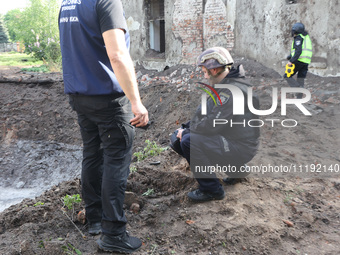 KHARKIV, UKRAINE - APRIL 27, 2024 - Investigators stay by a crater at Psychiatric Hospital N3 in the Saltivskyi district following a nightti...