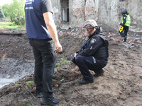 KHARKIV, UKRAINE - APRIL 27, 2024 - Investigators stay by a crater at Psychiatric Hospital N3 in the Saltivskyi district following a nightti...