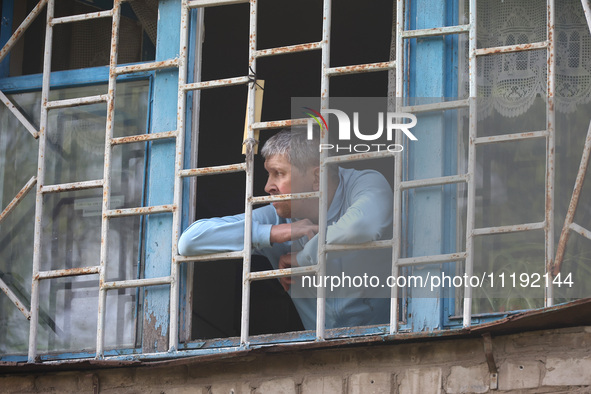 KHARKIV, UKRAINE - APRIL 27, 2024 - A man looks out of a grated window at Psychiatric Hospital N3 in the Saltivskyi district following a nig...