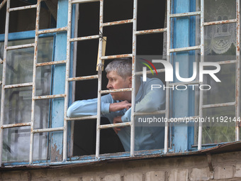 KHARKIV, UKRAINE - APRIL 27, 2024 - A man looks out of a grated window at Psychiatric Hospital N3 in the Saltivskyi district following a nig...