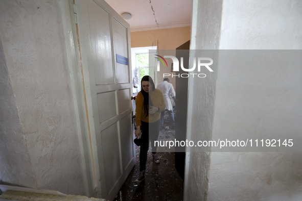 KHARKIV, UKRAINE - APRIL 27, 2024 - A woman leaves a room carpeted with glass shards at Psychiatric Hospital N3 in the Saltivskyi district f...