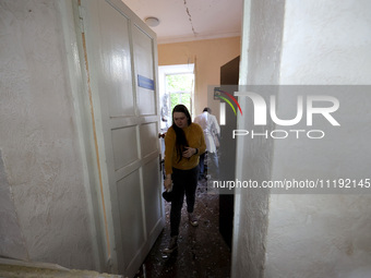 KHARKIV, UKRAINE - APRIL 27, 2024 - A woman leaves a room carpeted with glass shards at Psychiatric Hospital N3 in the Saltivskyi district f...