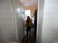 KHARKIV, UKRAINE - APRIL 27, 2024 - A woman leaves a room carpeted with glass shards at Psychiatric Hospital N3 in the Saltivskyi district f...