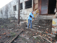 KHARKIV, UKRAINE - APRIL 27, 2024 - A man removes the soil from the steps at Psychiatric Hospital N3 in the Saltivskyi district following a...