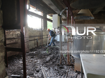 KHARKIV, UKRAINE - APRIL 27, 2024 - A man removes the soil from the food block at Psychiatric Hospital N3 in the Saltivskyi district followi...