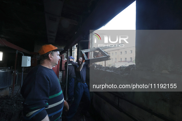 KHARKIV, UKRAINE - APRIL 27, 2024 - Men clean the premises of Psychiatric Hospital N3 in the Saltivskyi district following a nighttime Russi...