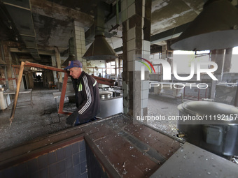 KHARKIV, UKRAINE - APRIL 27, 2024 - A man takes out a broken window frame at the food block of Psychiatric Hospital N3 in the Saltivskyi dis...