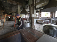 KHARKIV, UKRAINE - APRIL 27, 2024 - A man takes out a broken window frame at the food block of Psychiatric Hospital N3 in the Saltivskyi dis...