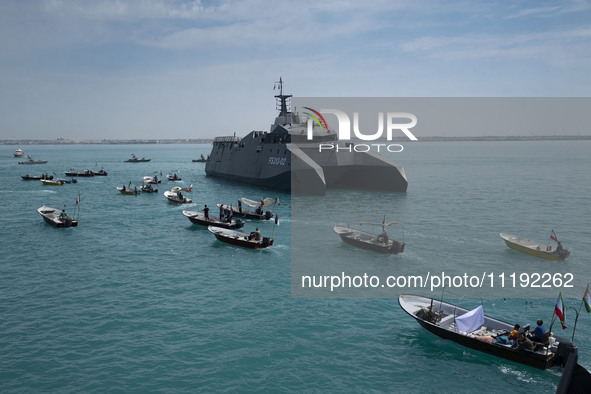 The Islamic Revolutionary Guard Corps (IRGC) Navy's Martyr Hassan Bagheri warship and Basij paramilitary force speed boats are sailing along...