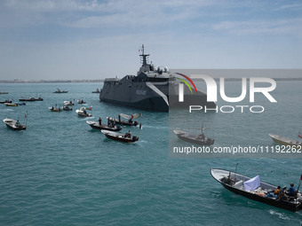 The Islamic Revolutionary Guard Corps (IRGC) Navy's Martyr Hassan Bagheri warship and Basij paramilitary force speed boats are sailing along...