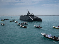 The Islamic Revolutionary Guard Corps (IRGC) Navy's Martyr Hassan Bagheri warship and Basij paramilitary force speed boats are sailing along...