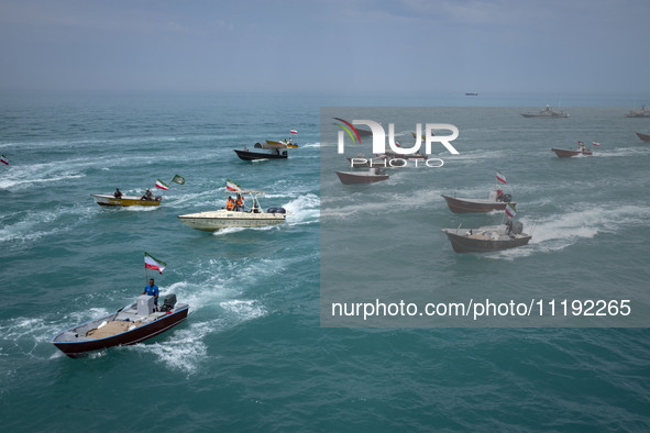 Basij paramilitary force speed boats are sailing along the Persian Gulf during the Islamic Revolutionary Guard Corps (IRGC) marine parade to...