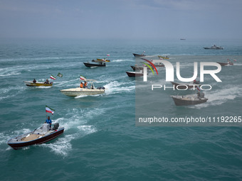 Basij paramilitary force speed boats are sailing along the Persian Gulf during the Islamic Revolutionary Guard Corps (IRGC) marine parade to...