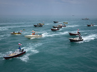 Basij paramilitary force speed boats are sailing along the Persian Gulf during the Islamic Revolutionary Guard Corps (IRGC) marine parade to...