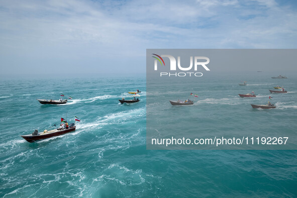 Basij paramilitary force speed boats are sailing along the Persian Gulf during the Islamic Revolutionary Guard Corps (IRGC) marine parade, w...