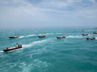 Basij paramilitary force speed boats are sailing along the Persian Gulf during the Islamic Revolutionary Guard Corps (IRGC) marine parade, w...