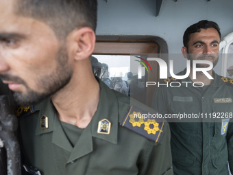 Two Islamic Revolutionary Guard Corps (IRGC) Navy military personnel are standing on a warship during the IRGC marine parade in honor of Per...