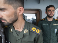 Two Islamic Revolutionary Guard Corps (IRGC) Navy military personnel are standing on a warship during the IRGC marine parade in honor of Per...