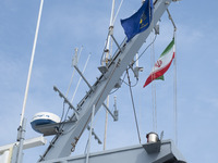 Two Islamic Revolutionary Guard Corps (IRGC) Navy military personnel are standing on a warship during the IRGC marine parade in honor of Per...