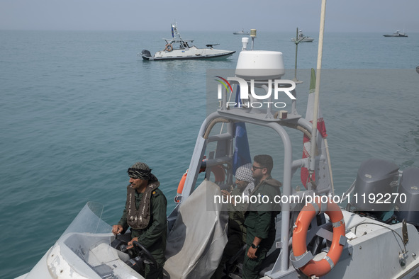 Islamic Revolutionary Guard Corps (IRGC) Navy military personnel are standing on a speed boat during the IRGC marine parade commemorating th...