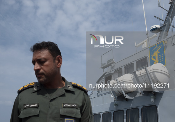 An Islamic Revolutionary Guard Corps (IRGC) Navy military personnel is standing on a warship during the IRGC marine parade commemorating the...