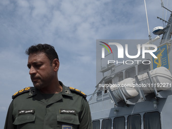 An Islamic Revolutionary Guard Corps (IRGC) Navy military personnel is standing on a warship during the IRGC marine parade commemorating the...