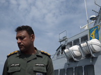 An Islamic Revolutionary Guard Corps (IRGC) Navy military personnel is standing on a warship during the IRGC marine parade commemorating the...