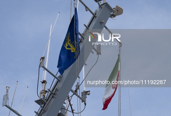 An Iranian flag and a flag of the Islamic Revolutionary Guard Corps (IRGC) are hanging on a warship as it participates in the IRGC marine pa...