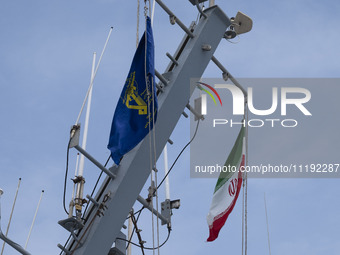 An Iranian flag and a flag of the Islamic Revolutionary Guard Corps (IRGC) are hanging on a warship as it participates in the IRGC marine pa...