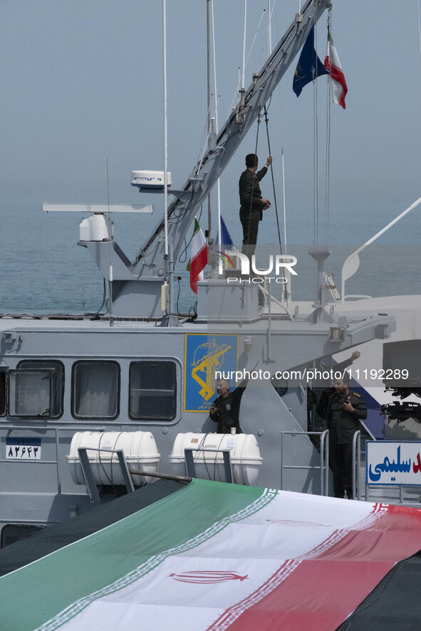 Islamic Revolutionary Guard Corps (IRGC) Navy military personnel are standing on a warship during the IRGC marine parade commemorating the P...