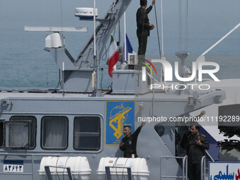 Islamic Revolutionary Guard Corps (IRGC) Navy military personnel are standing on a warship during the IRGC marine parade commemorating the P...