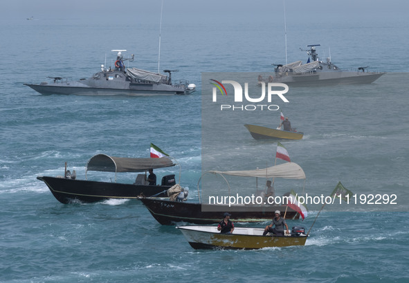 Two Islamic Revolutionary Guard Corps (IRGC) Navy warships and Basij paramilitary force speed boats are sailing along the Persian Gulf durin...