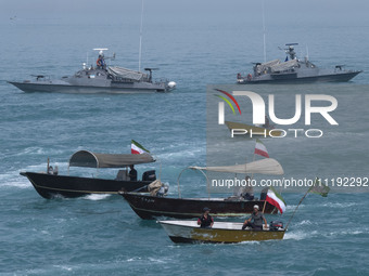 Two Islamic Revolutionary Guard Corps (IRGC) Navy warships and Basij paramilitary force speed boats are sailing along the Persian Gulf durin...