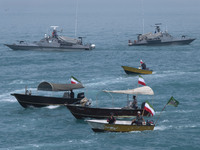 Two Islamic Revolutionary Guard Corps (IRGC) Navy warships and Basij paramilitary force speed boats are sailing along the Persian Gulf durin...