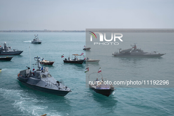 Islamic Revolutionary Guard Corps (IRGC) Navy warships and Basij paramilitary force speed boats are sailing along the Persian Gulf during th...