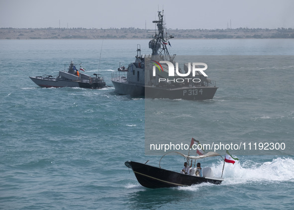 The Islamic Revolutionary Guard Corps (IRGC) Navy Martyr Tavassoli warship is sailing along the Persian Gulf, while a Basij paramilitary for...