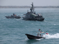 The Islamic Revolutionary Guard Corps (IRGC) Navy Martyr Tavassoli warship is sailing along the Persian Gulf, while a Basij paramilitary for...