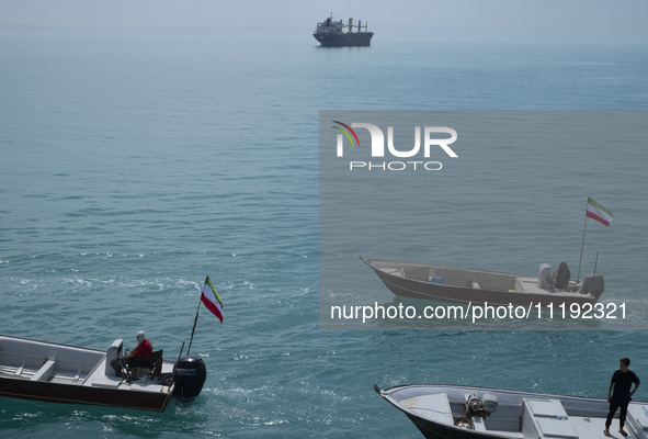 Basij paramilitary force speed boats are participating in a marine parade to commemorate Persian Gulf National Day, near the Bushehr nuclear...