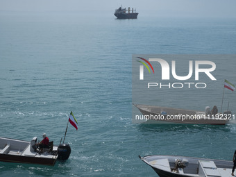 Basij paramilitary force speed boats are participating in a marine parade to commemorate Persian Gulf National Day, near the Bushehr nuclear...