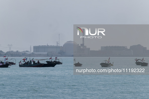 Basij paramilitary force speed boats are sailing along the Persian Gulf near the Bushehr nuclear power plant during the IRGC marine parade c...