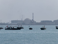 Basij paramilitary force speed boats are sailing along the Persian Gulf near the Bushehr nuclear power plant during the IRGC marine parade c...