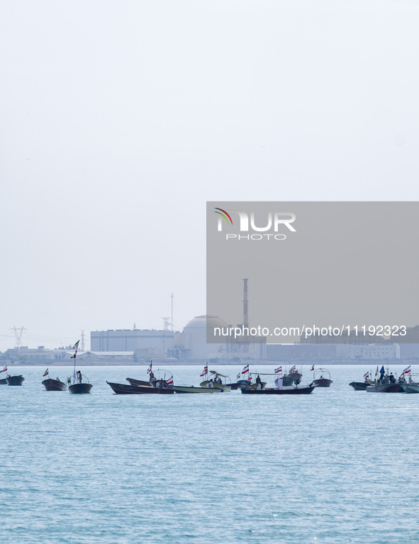 Basij paramilitary force speed boats are sailing along the Persian Gulf near the Bushehr nuclear power plant during the IRGC marine parade t...