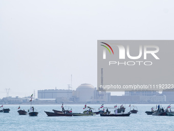 Basij paramilitary force speed boats are sailing along the Persian Gulf near the Bushehr nuclear power plant during the IRGC marine parade t...