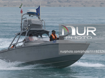 An Islamic Revolutionary Guard Corps (IRGC) speed boat is sailing along the Persian Gulf during the IRGC marine parade to commemorate the Pe...